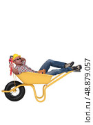 Unmotivated laborer resting in a wheelbarrow. Стоковое фото, агентство Ingram Publishing / Фотобанк Лори