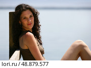 Summery woman sitting on a wooden jetty. Стоковое фото, агентство Ingram Publishing / Фотобанк Лори