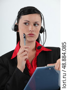 Call centre agent considering her options. Стоковое фото, агентство Ingram Publishing / Фотобанк Лори