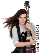 Woman hugging her guitar. Стоковое фото, агентство Ingram Publishing / Фотобанк Лори