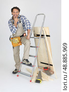 portrait of cabinetmaker posing near ladder. Стоковое фото, агентство Ingram Publishing / Фотобанк Лори