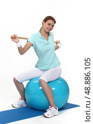Young woman with an exercise ball. Стоковое фото, агентство Ingram Publishing / Фотобанк Лори