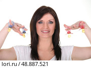 Woman brandishing pacifiers. Стоковое фото, агентство Ingram Publishing / Фотобанк Лори