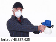 Man with a paint sprayer. Стоковое фото, агентство Ingram Publishing / Фотобанк Лори