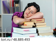 Overworked woman sleeping on a stack of books. Стоковое фото, агентство Ingram Publishing / Фотобанк Лори