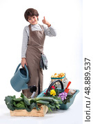 a little boy dressed in gardener. Стоковое фото, агентство Ingram Publishing / Фотобанк Лори