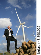 senior engineer phoning outdoors near windmills. Стоковое фото, агентство Ingram Publishing / Фотобанк Лори
