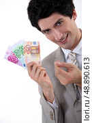 Rich businessman showing off his money. Стоковое фото, агентство Ingram Publishing / Фотобанк Лори