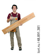 Handyman carrying plank on white background. Стоковое фото, агентство Ingram Publishing / Фотобанк Лори