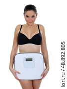 Woman in underwear in front of scales. Стоковое фото, агентство Ingram Publishing / Фотобанк Лори