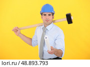 Engineer holding a rolled-up blueprint. Стоковое фото, агентство Ingram Publishing / Фотобанк Лори