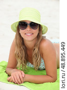 Pretty girl suntanning at the beach. Стоковое фото, агентство Ingram Publishing / Фотобанк Лори