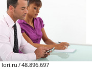 Business couple going over accounts. Стоковое фото, агентство Ingram Publishing / Фотобанк Лори