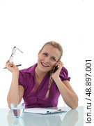Young woman laughing on the phone. Стоковое фото, агентство Ingram Publishing / Фотобанк Лори