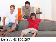 Three lads relaxing at home. Стоковое фото, агентство Ingram Publishing / Фотобанк Лори