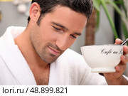 Man in a bathrobe with a cup of coffee and a pen. Стоковое фото, агентство Ingram Publishing / Фотобанк Лори