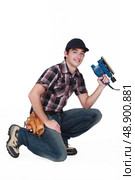 portrait of young carpenter with sander machine. Стоковое фото, агентство Ingram Publishing / Фотобанк Лори