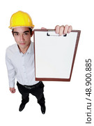 Engineer holding up a blank clipboard. Стоковое фото, агентство Ingram Publishing / Фотобанк Лори