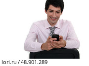 Businessman sending text message. Стоковое фото, агентство Ingram Publishing / Фотобанк Лори