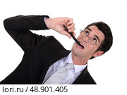 Businessman chewing his pen. Стоковое фото, агентство Ingram Publishing / Фотобанк Лори