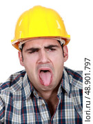 Construction worker with his tongue out. Стоковое фото, агентство Ingram Publishing / Фотобанк Лори