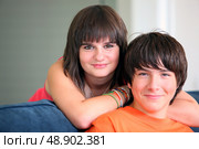 Brother and sister sat on couch. Стоковое фото, агентство Ingram Publishing / Фотобанк Лори