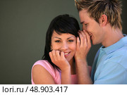 man telling a secret to his girlfriend. Стоковое фото, агентство Ingram Publishing / Фотобанк Лори