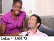 Man and woman entertaining playing video games. Стоковое фото, агентство Ingram Publishing / Фотобанк Лори