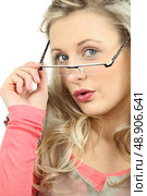 Woman peering over her glasses. Стоковое фото, агентство Ingram Publishing / Фотобанк Лори