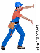 Tradesman pushing an invisible wall. Стоковое фото, агентство Ingram Publishing / Фотобанк Лори