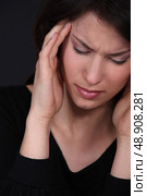 Woman suffering from a throbbing headache. Стоковое фото, агентство Ingram Publishing / Фотобанк Лори