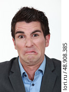 Portrait of a man grimacing. Стоковое фото, агентство Ingram Publishing / Фотобанк Лори