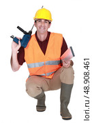 Worker kneeling with drill. Стоковое фото, агентство Ingram Publishing / Фотобанк Лори