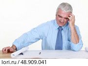 Architect dubious of his plans. Стоковое фото, агентство Ingram Publishing / Фотобанк Лори