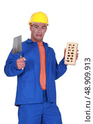 Mason holding a trowel. Стоковое фото, агентство Ingram Publishing / Фотобанк Лори