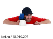 Playful man holding a spray gun. Стоковое фото, агентство Ingram Publishing / Фотобанк Лори