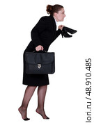 Woman sneaking out of the office. Стоковое фото, агентство Ingram Publishing / Фотобанк Лори