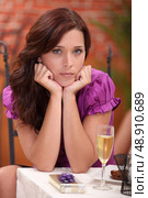 Upset woman sat alone at the restaurant. Стоковое фото, агентство Ingram Publishing / Фотобанк Лори