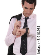 Businessman checking his watch for the time. Стоковое фото, агентство Ingram Publishing / Фотобанк Лори