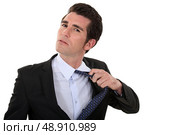 Man untying his tie. Стоковое фото, агентство Ingram Publishing / Фотобанк Лори