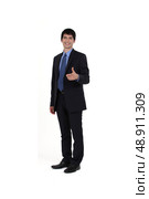 Young businessman giving thumbs-up gesture. Стоковое фото, агентство Ingram Publishing / Фотобанк Лори