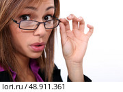 bespectacled woman knitting her brows. Стоковое фото, агентство Ingram Publishing / Фотобанк Лори