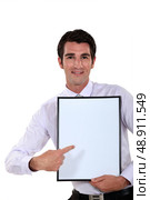 Man holding up a blank bulletin board. Стоковое фото, агентство Ingram Publishing / Фотобанк Лори