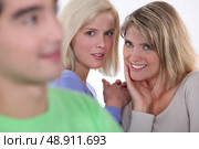 Tow girls gossiping about boy. Стоковое фото, агентство Ingram Publishing / Фотобанк Лори