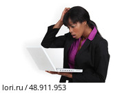 An African American businesswoman looking at her laptop with a dubious expression. Стоковое фото, агентство Ingram Publishing / Фотобанк Лори