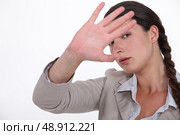 Woman trying to block out the camera. Стоковое фото, агентство Ingram Publishing / Фотобанк Лори