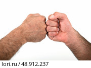Two men bumping fists. Стоковое фото, агентство Ingram Publishing / Фотобанк Лори