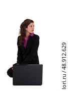 attractive young businesswoman crouching with laptop. Стоковое фото, агентство Ingram Publishing / Фотобанк Лори