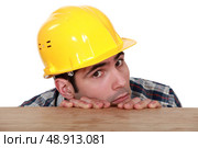 A fearful and timid tradesman. Стоковое фото, агентство Ingram Publishing / Фотобанк Лори