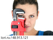 The jaw of a pipe wrench framing a woman’s eye. Стоковое фото, агентство Ingram Publishing / Фотобанк Лори